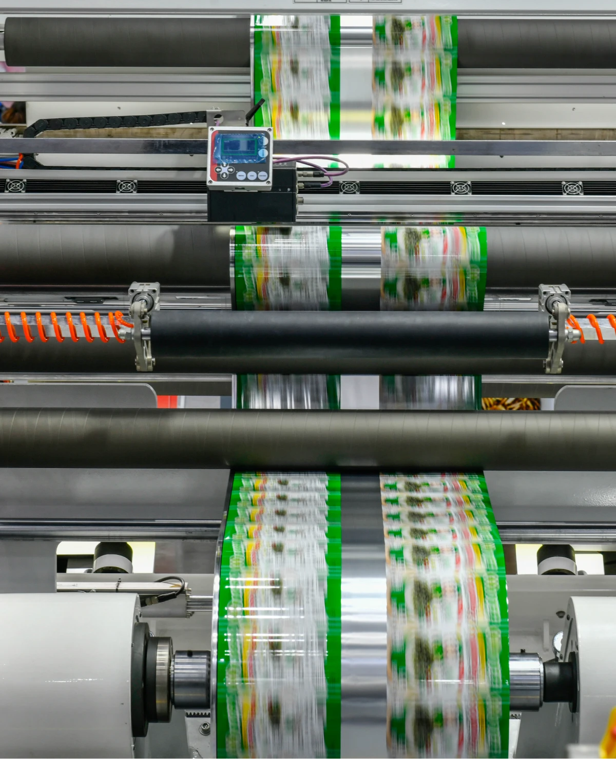 Printing machine with colorful paper rolls.